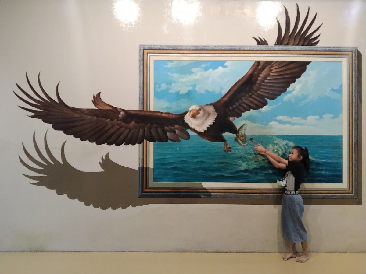 Tourists posing with 3D trick art at Art in Paradise Pattaya