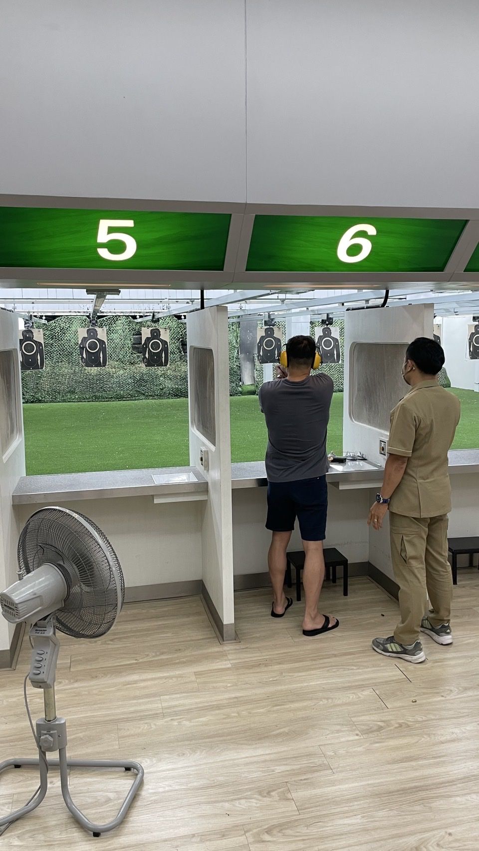 Visitor at shooting range in Pattaya with instructor