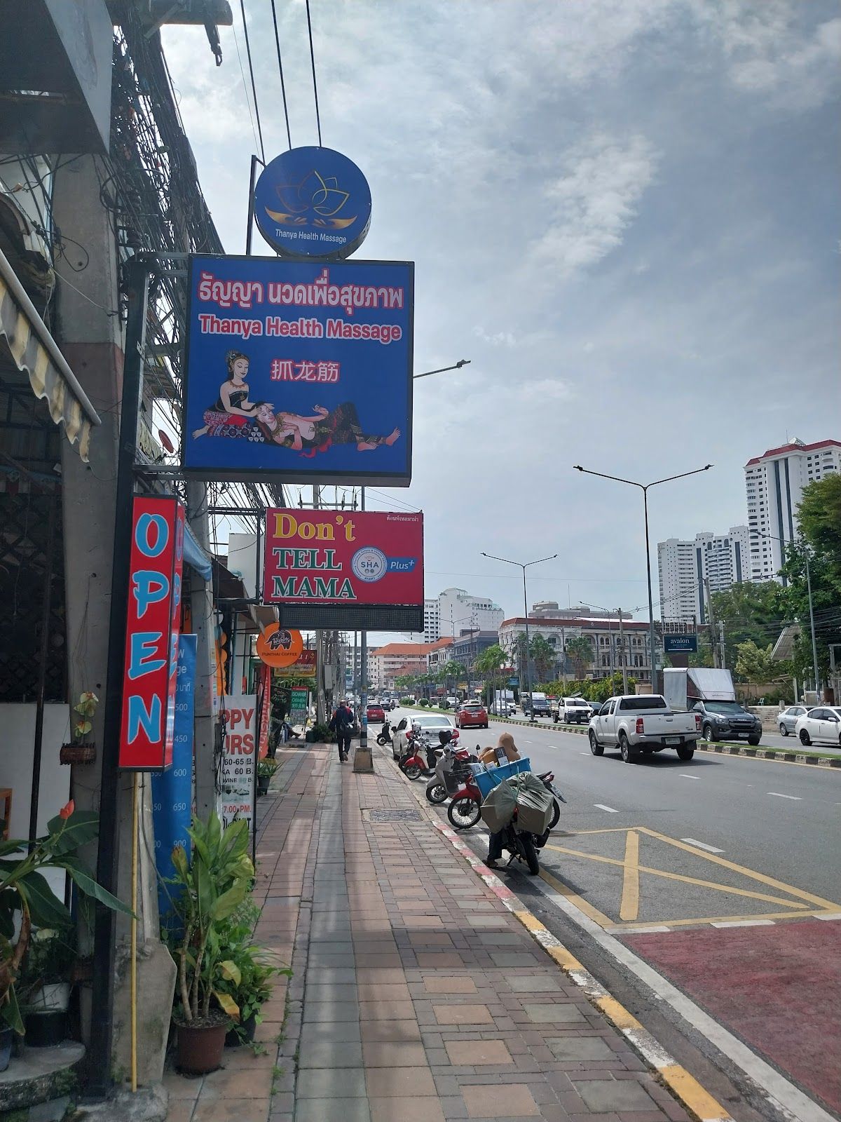 Interior of a Thai massage parlour in Pattaya with clean glass-partitioned private rooms and floor mats