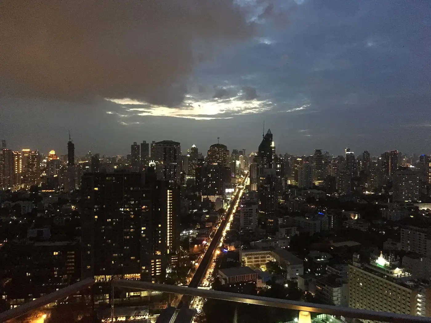 Bangkok's towers at dusk, seen from a rooftop bar