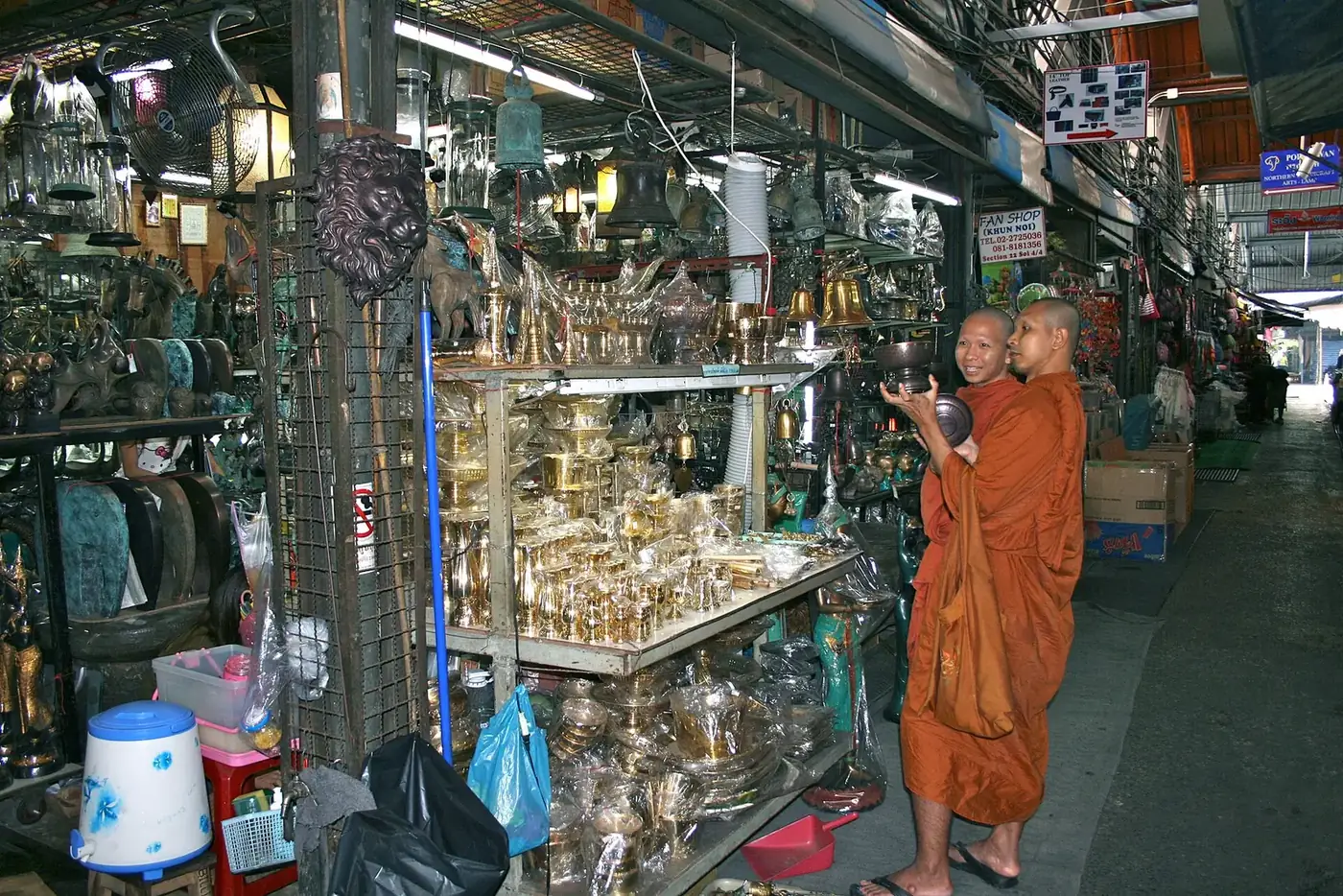 Shoppers in a crowded aisle at Chatuchak Weekend Market in Bangkok