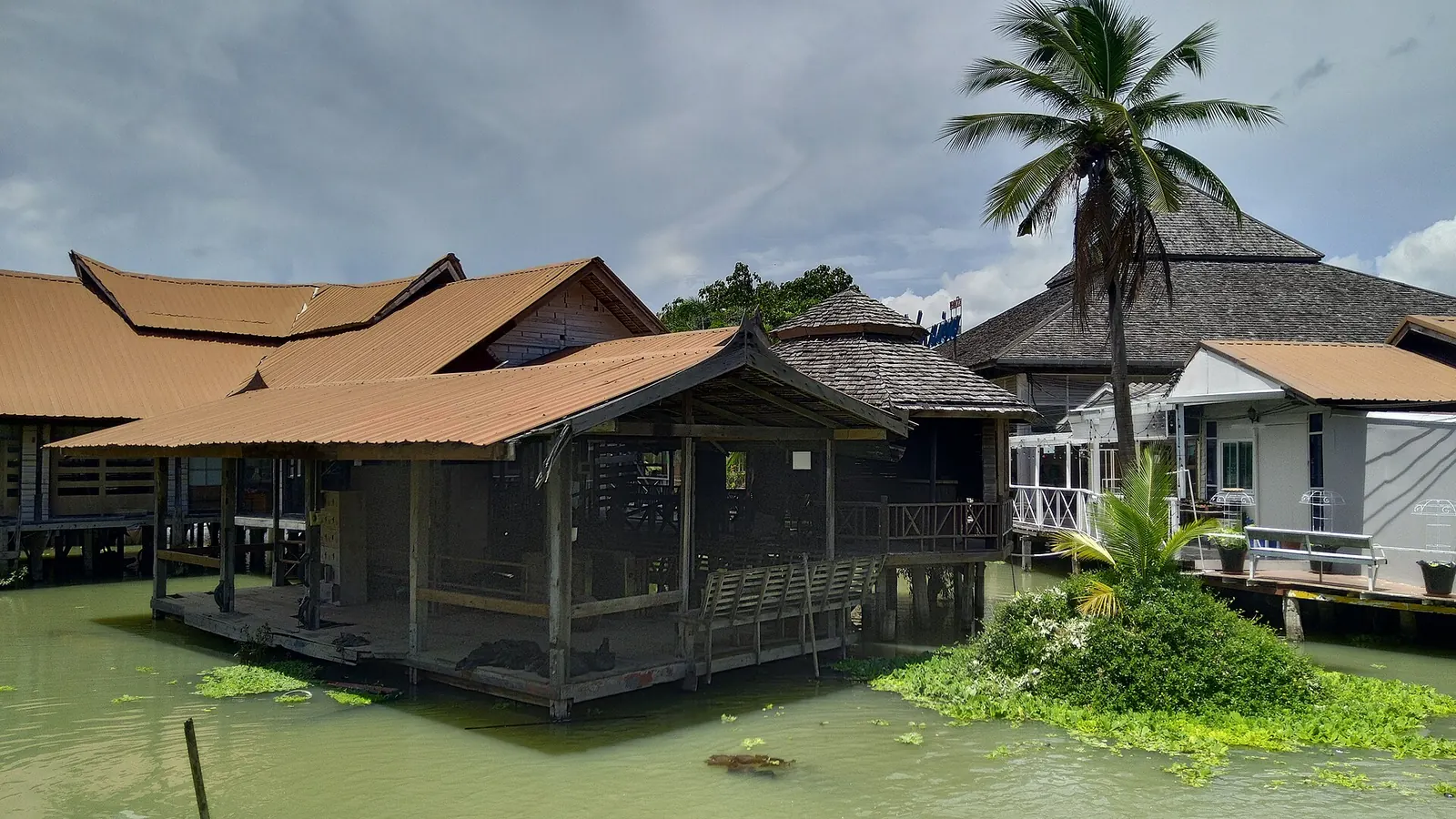 Wooden boats on a canal at Pattaya Floating Market