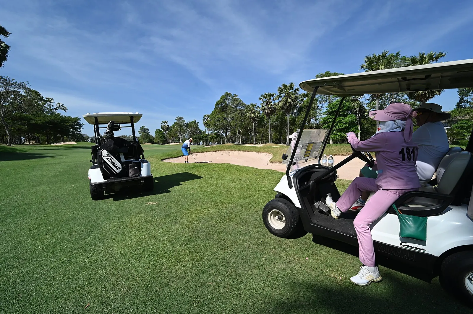 Golfers in carts on a Pattaya-area fairway, course unnamed