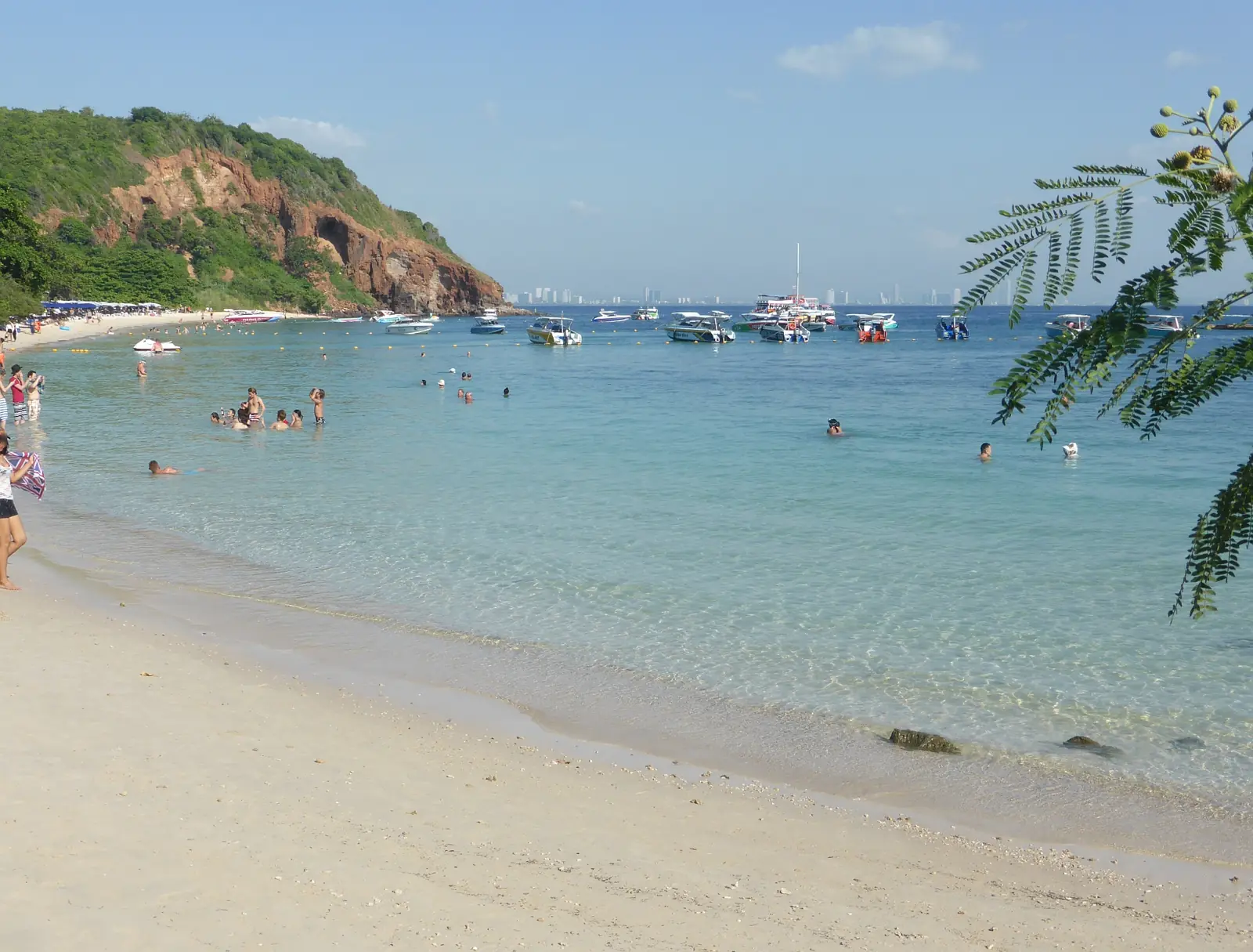 A sandy cove on Koh Larn with clear shallow water