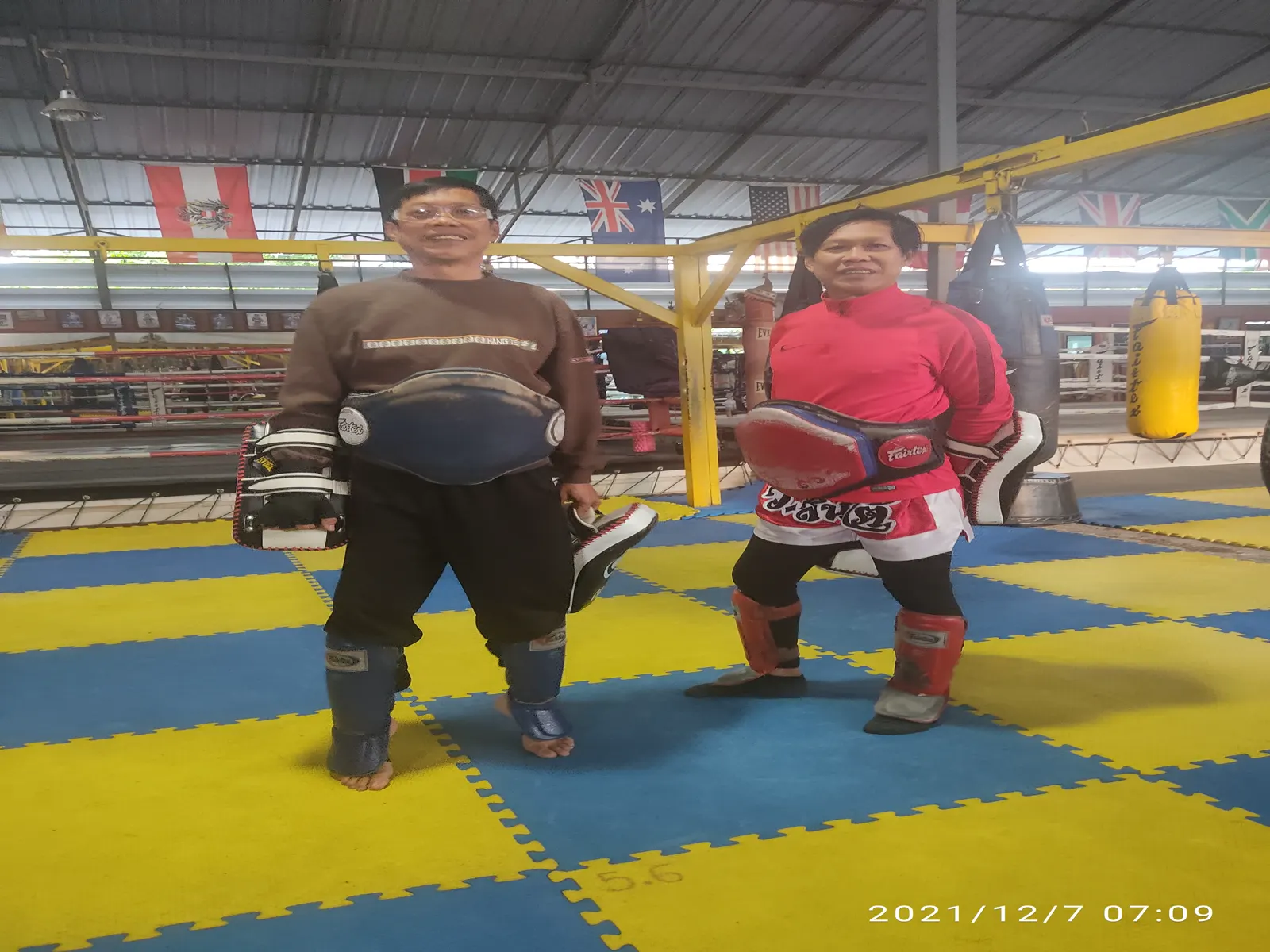 Two Muay Thai trainers in a Thai gym in December 2021, gym not named