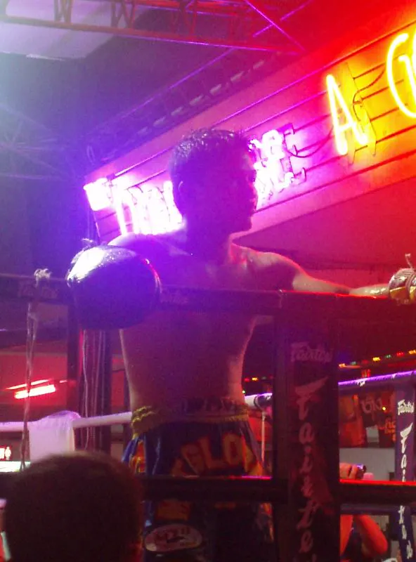 A Muay Thai fighter after a bout in a Pattaya bar, not inside a stadium
