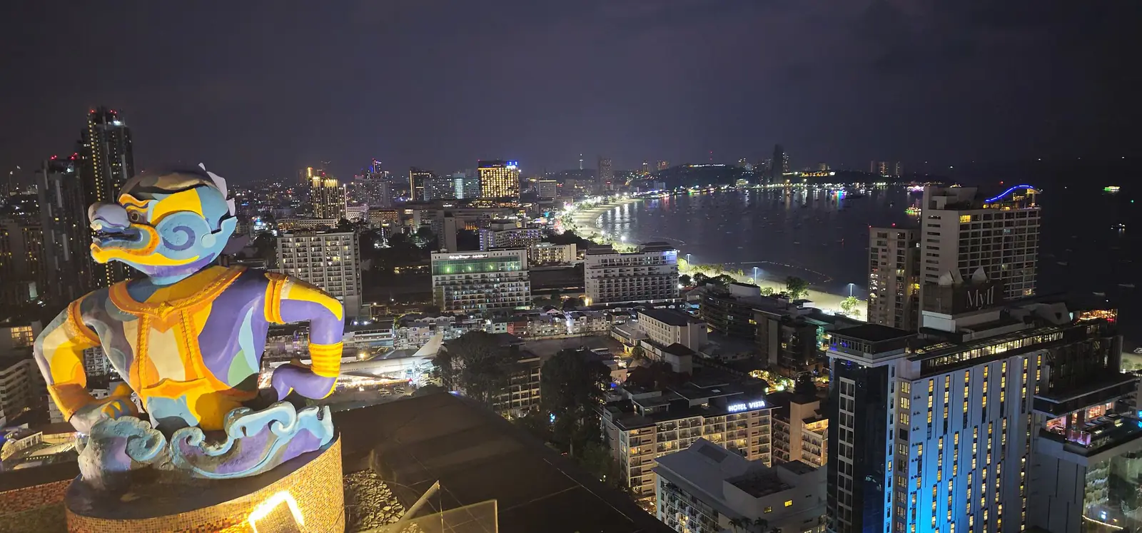 Pattaya Beach Road at night with illuminated hotel towers along the bay