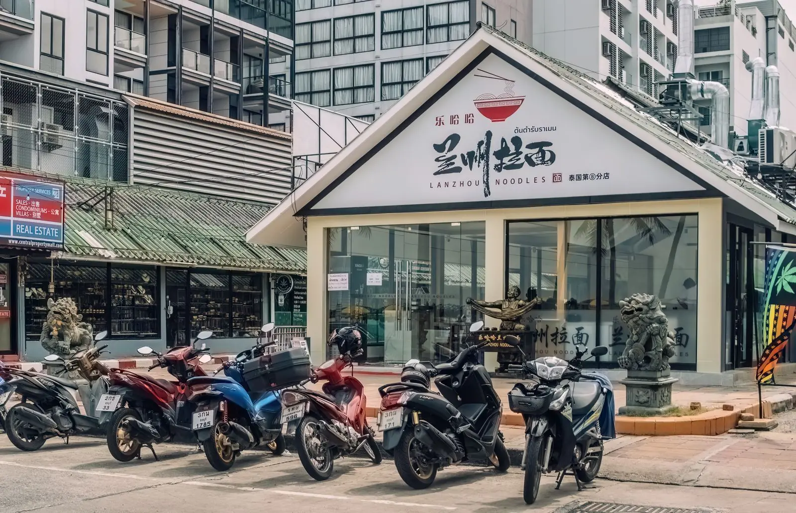 A small noodle shop open to the street in Pattaya, with motorbikes parked outside