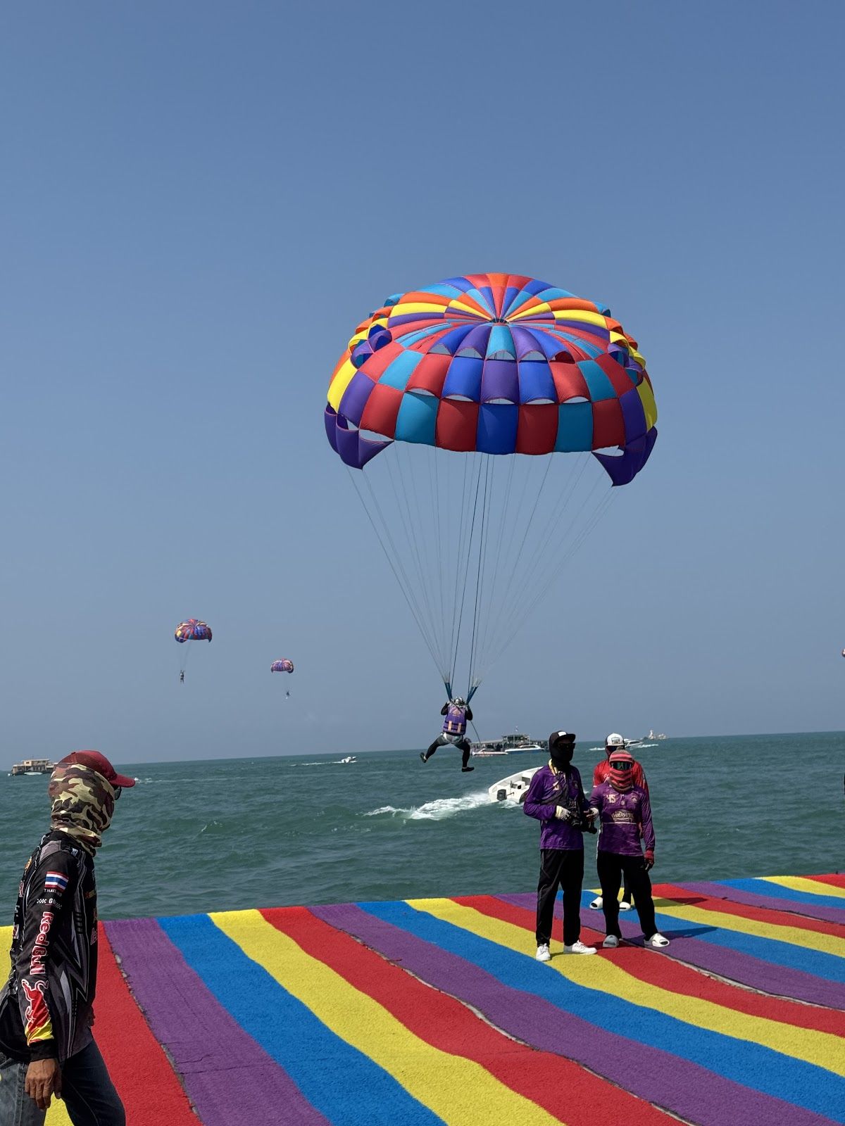 Parasailing over Pattaya Bay with city skyline in background
