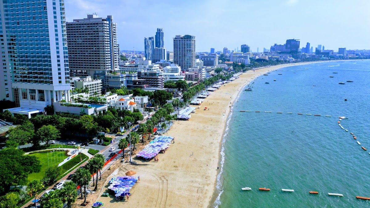 Aerial view of Pattaya's beachfront and Beach Road curving along the bay, with hotels lining the strip