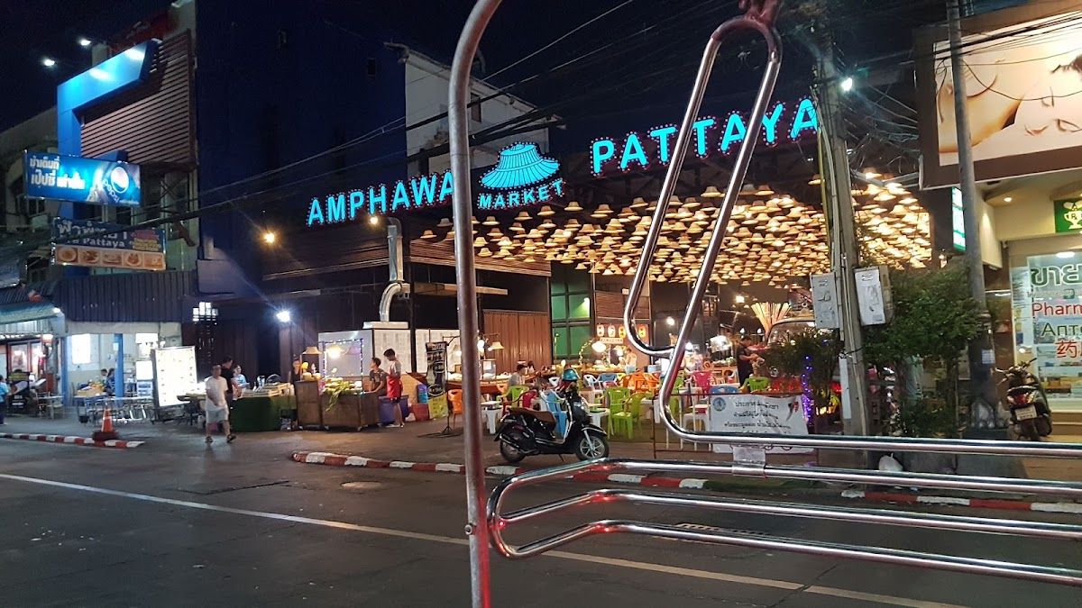Amphawa Market Pattaya at night with neon signs and food stalls along the entrance