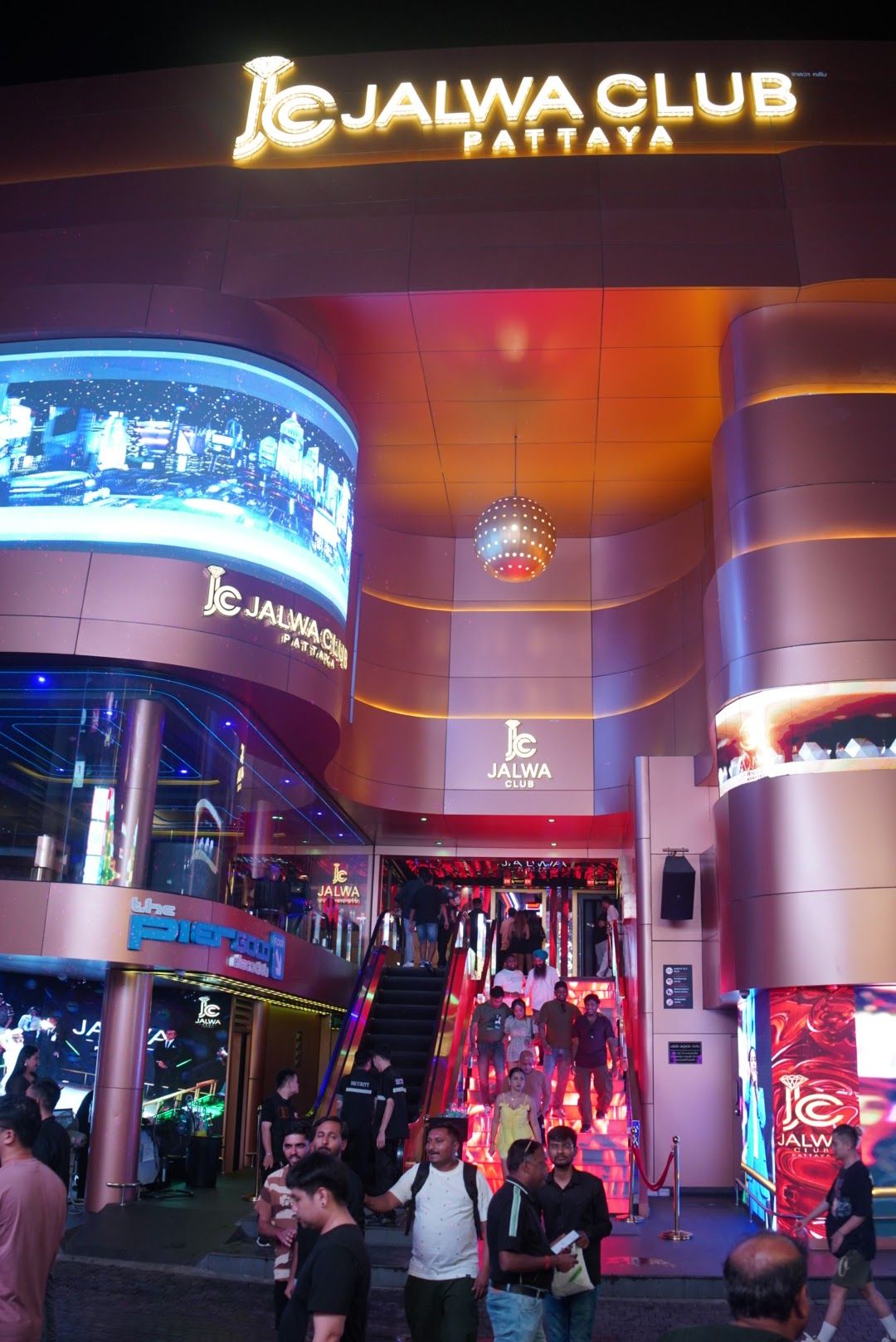 Crowds outside Jalwa Club on Pattaya's Walking Street at night, with neon signs and venue lights