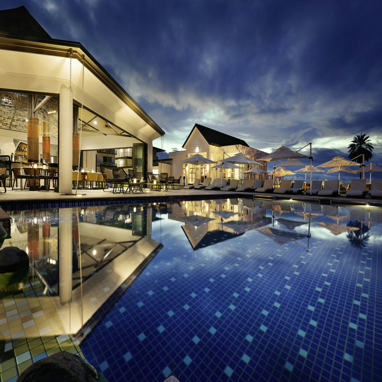 Rooftop infinity pool overlooking Pattaya bay at dusk